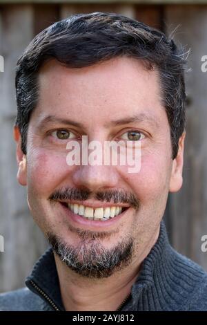 Portrait of a smiling man with facial hair Stock Photo