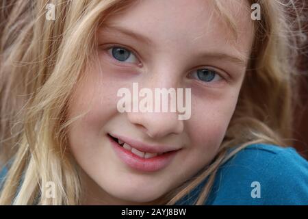 Closeup of a smiling beautiful innocent blonde teenage girl Stock Photo