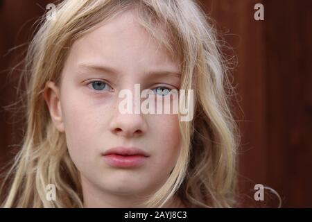 Portrait of a young teenage girl with a serious stare