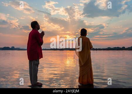 VRINDAVAN, INDIA - SEPTEMBER 20, 2019: Unidentified pilgrims praying at the Yamuna river in Vrindavan city in Uttar Pradesh state of India