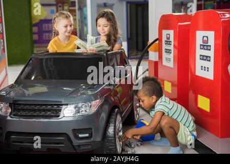 Kids at gas station in playroom Stock Photo