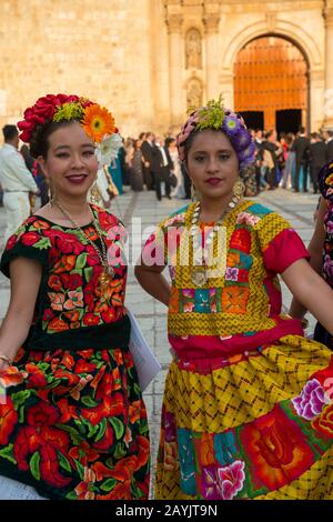 Women posing dressed in regional costumes in the city of Oaxaca de Juarez, Oaxaca, Mexico. Stock Photo