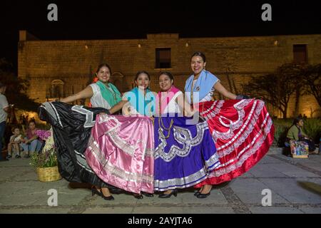 Women posing dressed in regional costumes in the city of Oaxaca de Juarez, Oaxaca, Mexico. Stock Photo