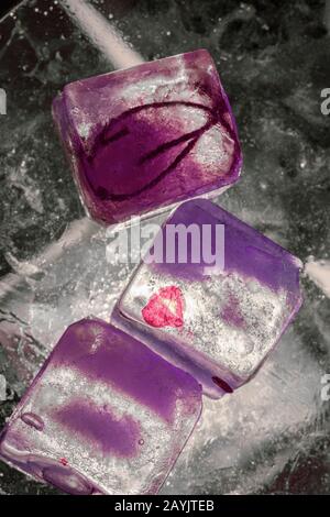 Illuminated ice cubes on glass - creative abstract background in magenta tones Stock Photo