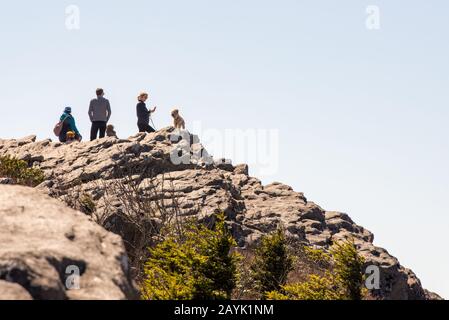 Large boulders provide the perfect place for careful visitors to photograph the seemingly endless vistas at Grandfather Mountain in Linville, NC. Stock Photo