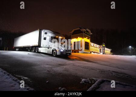 Freight truck industry. Dry Van truck  and trailer at night Stock Photo