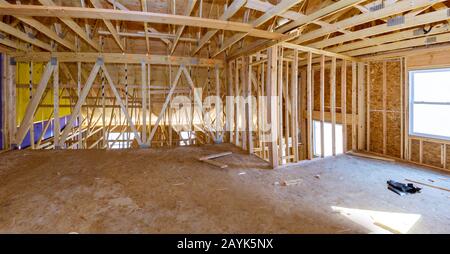 Inside unfinished the attic wooden roof framework timber beam of new house Stock Photo