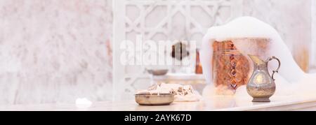 Water jar, towel and copper bowl with soap foam in turkish hamam. Traditional interior details. Horizontal, wide screen format, banner format Stock Photo