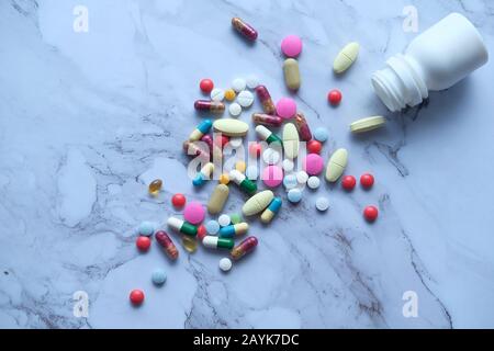 top view of pill spilling from container  Stock Photo