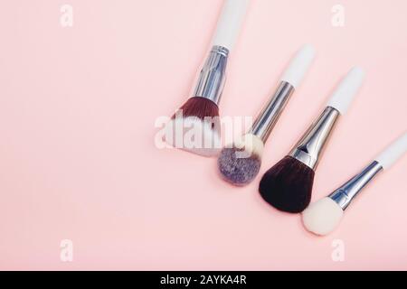 Set makeup brushes on pink color background. Top view point, flat lay Stock Photo