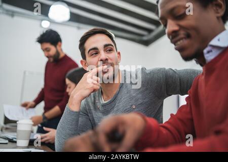 Two creative designers working in a project together and sharing new ideas on workplace. Business and team work concept. Stock Photo