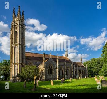 BOOTON, NORFOLK, UK - JUNE 14, 2018:  Side view of the parish Church of St Michael the Archangel in evening light Stock Photo