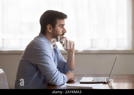 Pensive male look in distance thinking of problem solution Stock Photo