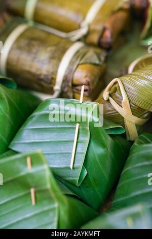 Glutinous rice steamed in banana leaf Khao Tom Mat or Khao Tom Pad food background Stock Photo
