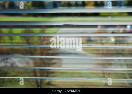 Window view through the blinds at the street through the blinds. Stock Photo