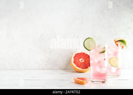 Sea Breeze Cocktail or Paloma Cocktail with grapefruit, lime and ice cubes, copy space. Summer brunch refreshing citrus cocktails. Stock Photo
