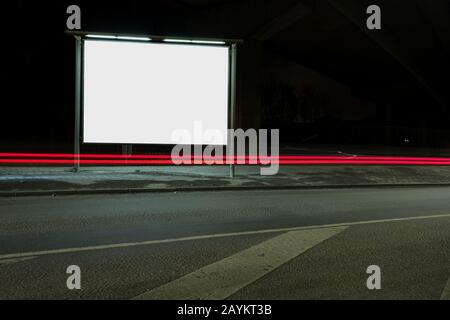 Square billboard mockup at night with car light trails Stock Photo