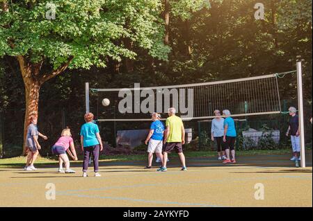 LEIPZIG, GERMANY - MAY 21, 2018: Senior people playing volleyball game on the court Stock Photo