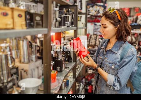 Asian happy girl shopping for kitchenware in retail store Stock Photo