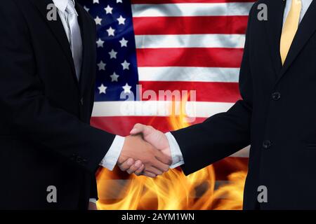 trade agreements and business practices in the United States concept. hand of businessman shaking on America flag background and fire Stock Photo