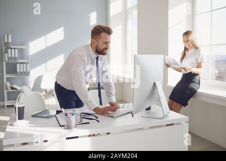 Positive businessman working confident in a white office. Stock Photo