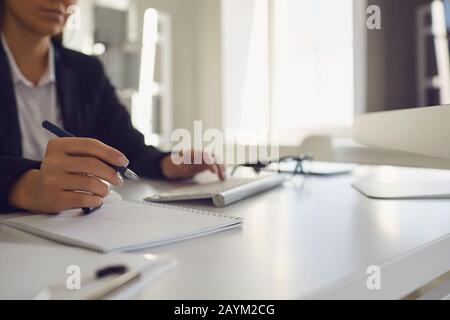 Work in the office at the computer. Business woman's handless face is typing on a computer keyboard. Stock Photo
