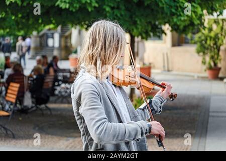 17 MAY 2018, BERLIN, GERMANY: Senior Street musician playing violin at the old city Stock Photo