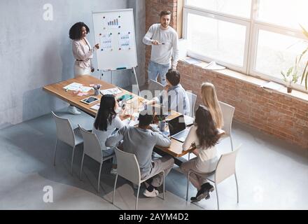 Colleagues making business presentation during meeting in office Stock Photo