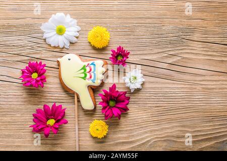 Easter gingerbread in the shape of a yellow bird on a wooden background Stock Photo