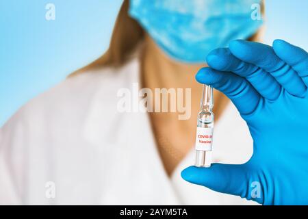 Doctor holds in his hand an ampoule with a vaccine against the new coronavirus COVID-19, close-up Stock Photo