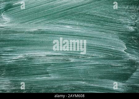 Green blackboard smeared with chalk Stock Photo