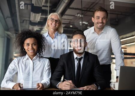 Portrait of pretty successful multi-ethnic corporate close-knit team Stock Photo