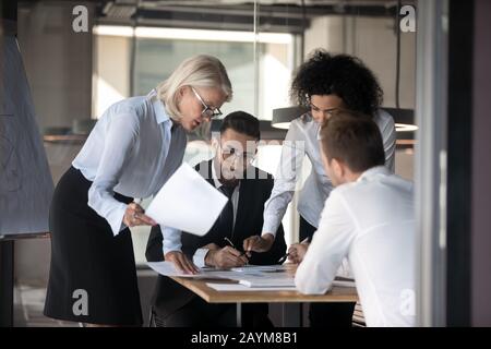 Multi-ethnic businesspeople financiers analyzing financial statistics work results Stock Photo