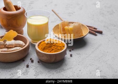 Healthy drink golden turmeric milk in glass cup Stock Photo