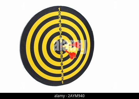 Three darts at the center of a dart board. Stock Photo