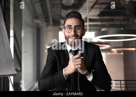 Arabian businessman looking at camera make videocall having distant conversation Stock Photo