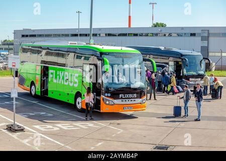 BERLIN, GERMANY, 20 MAY 2018: Flixbus at the bus stop station and passengers at Schonefeld Airport Stock Photo