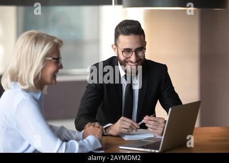 Diverse cheerful client and company representative at meeting in office Stock Photo