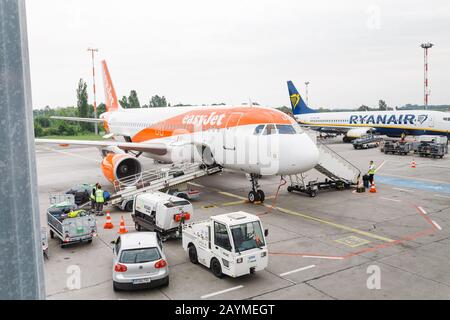 16 MAY 2018, BERLIN, GERMANY: Lowcost Airplanes of EasyJet and Ryanair being preparing ready for takeoff in international airport Schonefeld Stock Photo