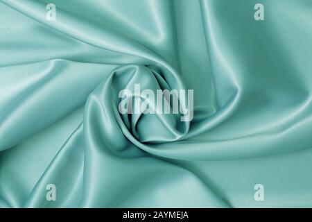 Trendy mint color background from silk draped fabric. Stock Photo