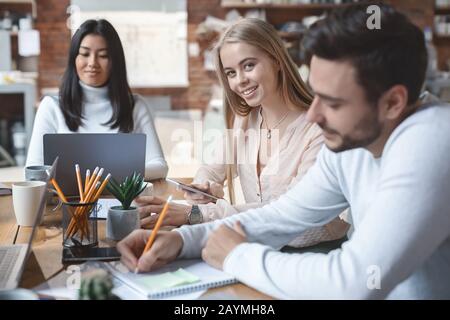 Close up of young multiracial business team working on project Stock Photo