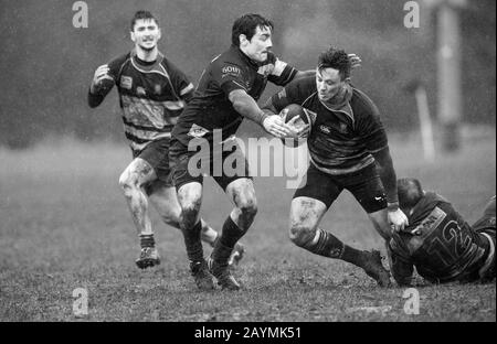 Amateur Rugby Union players carry on playing in driving rain and strong winds. Stock Photo