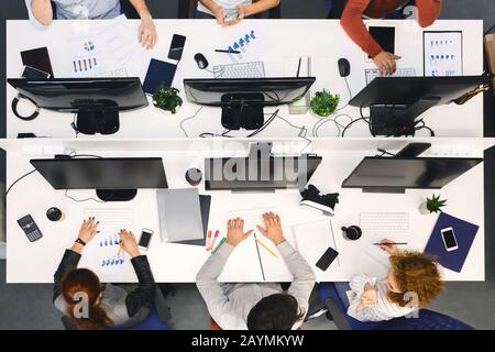 Top view of team working on computers at office Stock Photo