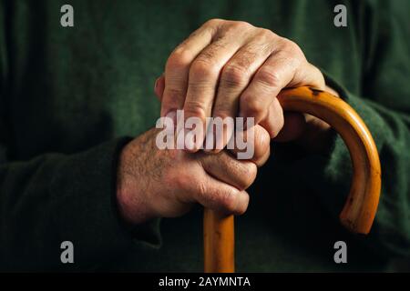 Senior disabled man clasping his walking stick Stock Photo