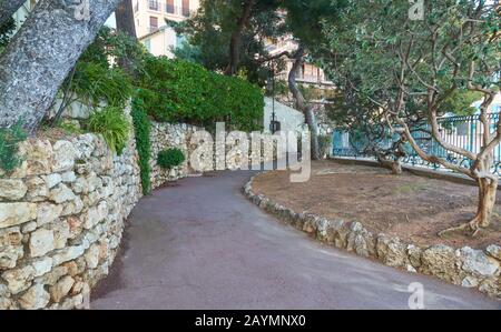 Monaco - April 05, 2019: Pedestrian walkway in the garden near Prince's Palace of Monaco Stock Photo