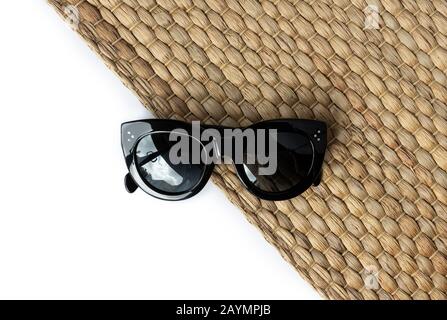 Creative composition with sunglasses and straw napkin on white background Stock Photo