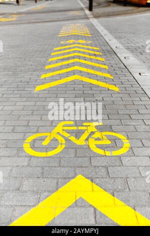 Bicycle lane sign on pedestrian side of the street Stock Photo