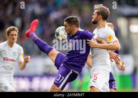 Aue, Germany. 16th Feb, 2020. Football: 2nd Bundesliga, FC Erzgebirge Aue - Holstein Kiel, 22nd matchday, at the Sparkassen-Erzgebirgsstadion. Aues Pascal Testroet (l) misses the ball next to Kiels Stefan Thesker. Credit: Robert Michael/dpa-Zentralbild/dpa - IMPORTANT NOTE: In accordance with the regulations of the DFL Deutsche Fußball Liga and the DFB Deutscher Fußball-Bund, it is prohibited to exploit or have exploited in the stadium and/or from the game taken photographs in the form of sequence images and/or video-like photo series./dpa/Alamy Live News