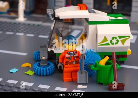 Tambov, Russian Federation - January 17, 2020 Lego cleaner minifigure with shovel near sweeper truck in the street. Studio shot. Stock Photo