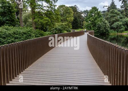 The Sackler Crossing bridge over the lake at the Royal Botanic Gardens, Kew, London Borough of Richmond upon Thames, Surrey, England. Stock Photo